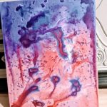 A painting for Carlie's Art Gallery with purple, blue, and red paint.