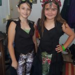 Two girls showcasing their steampunk outfits at Carlie's Art Gallery.