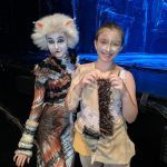 Two girls in cat costumes perform on stage at Carlie's Art Gallery.