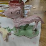 A child creates a horse clay sculpture at Carlie's Art Gallery.