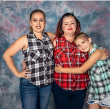 Three women in plaid shirts, promoting family time through a photo.